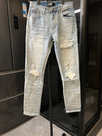 Light wash jeans with ripped knees and distressed patches on the thighs and calves