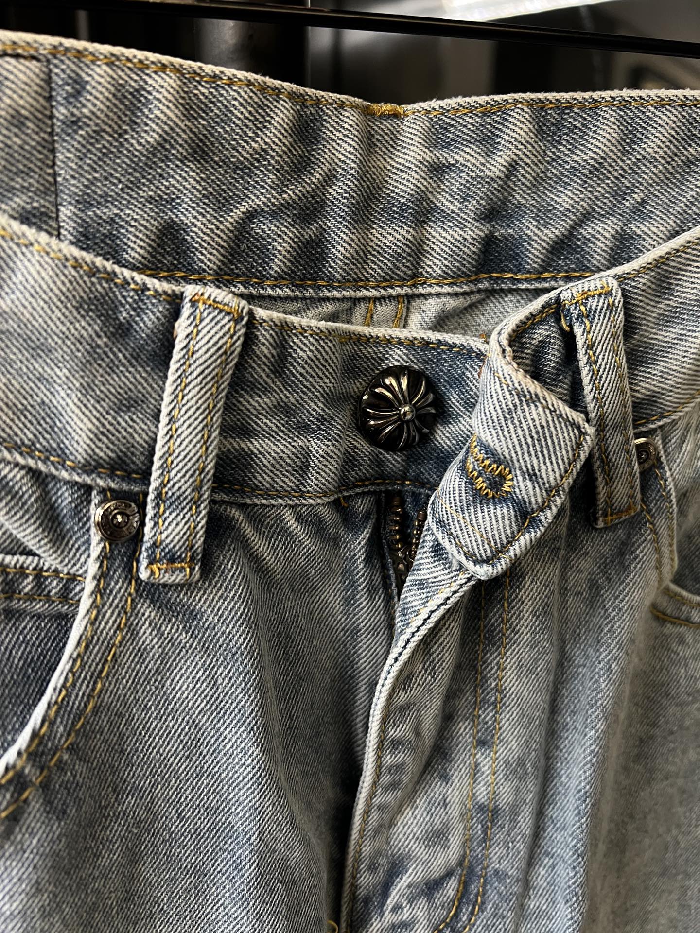 Denim waistband with button fly and metal button detail on light wash pants