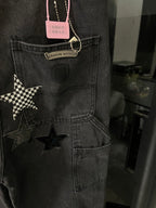 Dark gray denim pants with star appliques on cargo pocket and hanging tag