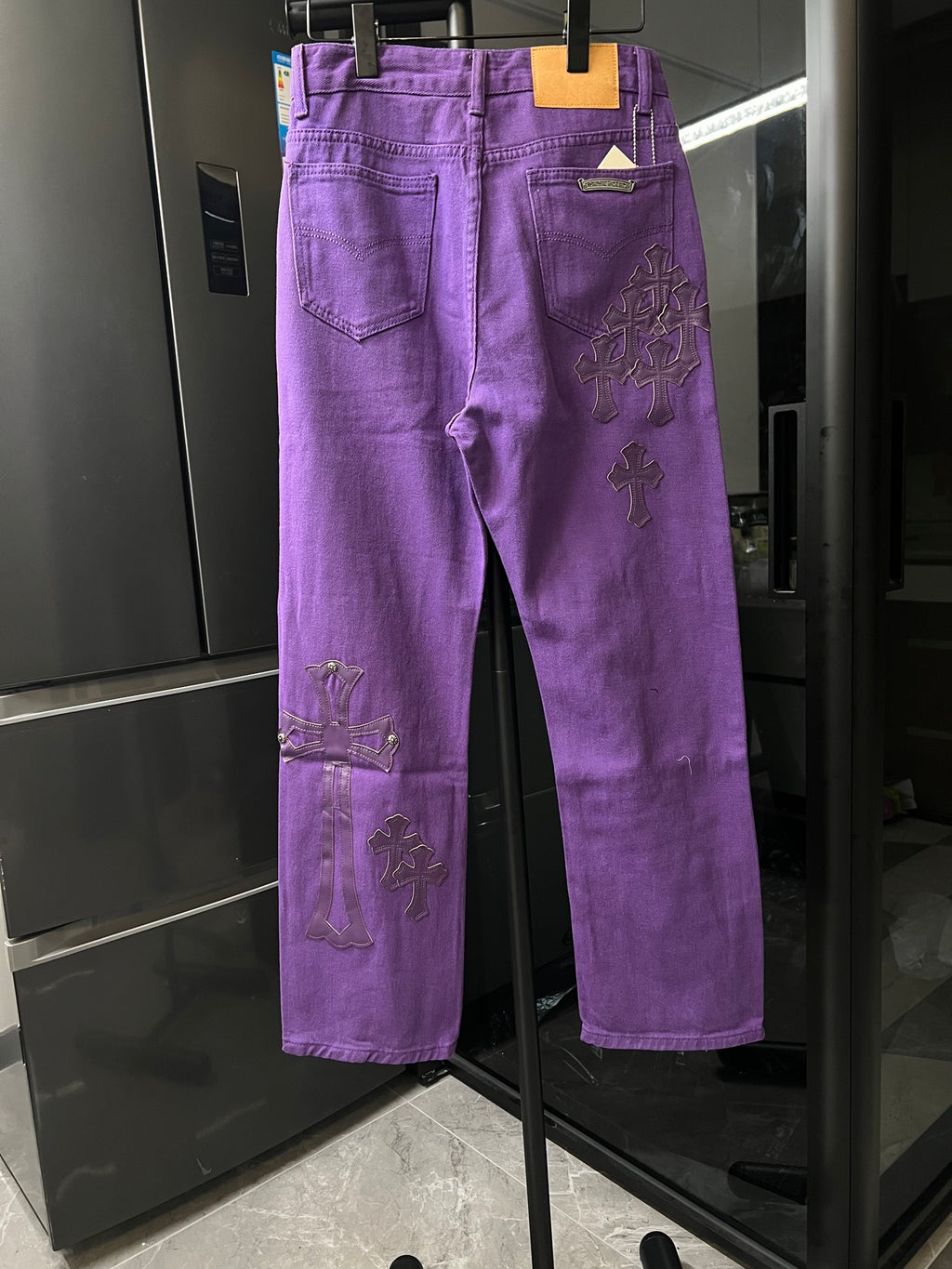 Purple pants with back pockets and embroidered cross patches, straight leg