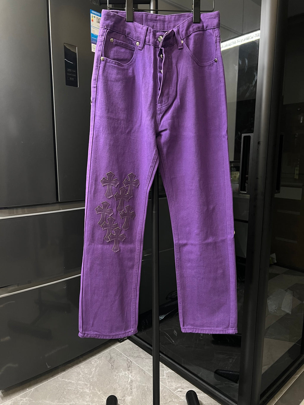 Purple pants with embroidered cross patches on the thigh, button fly, belt loops
