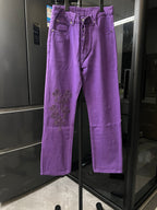 Purple pants with embroidered cross patches on the thigh, button fly, belt loops