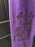 Purple pants leg with four embroidered cross motifs in raised stitch