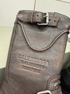 Balenciaga women’s leather boot with embossed logo, buckle strap, and stitched edges
