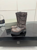 Balenciaga women’s mid-calf leather boots with buckle strap and textured lug outsole