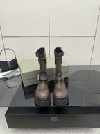 Balenciaga women’s mid-calf leather boots with side zipper, buckle straps, lug sole