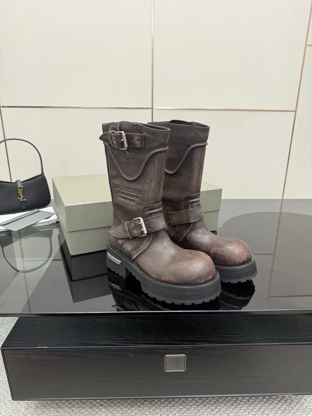 Balenciaga women’s mid-calf leather boots with double buckles and thick lug sole
