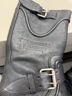 Gray leather boot with embossed logo and metal buckle strap