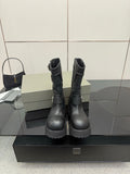 Black leather moto boots with lace-up and side buckles