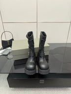 Black leather moto boots with lace-up and side buckles