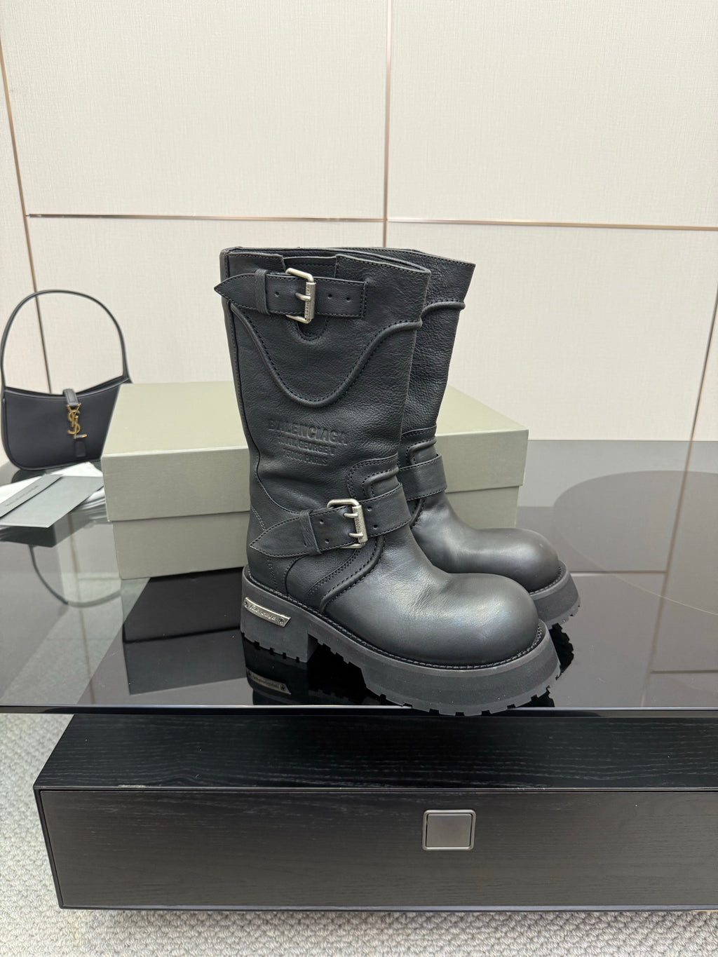 Black leather biker boots with double buckles and rugged lug sole