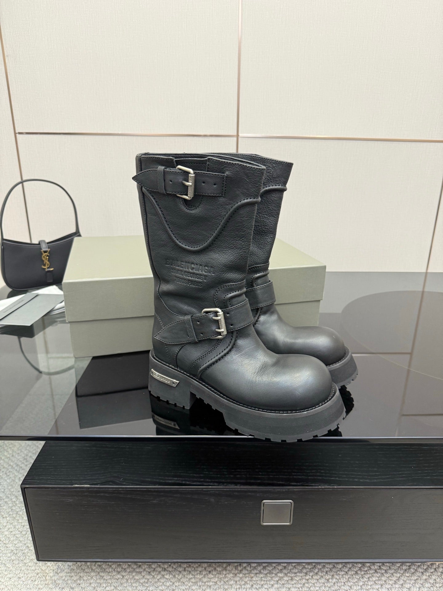 Black leather biker boots with double buckles and rugged lug sole