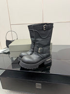 Black leather knee-high boots with strap buckles and lug sole