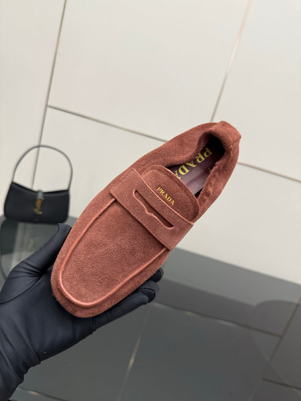 Prada rust-brown suede loafer close-up of insole logo and strap