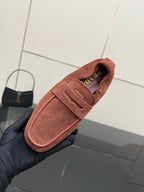 Prada rust-brown suede loafer close-up of insole logo and strap