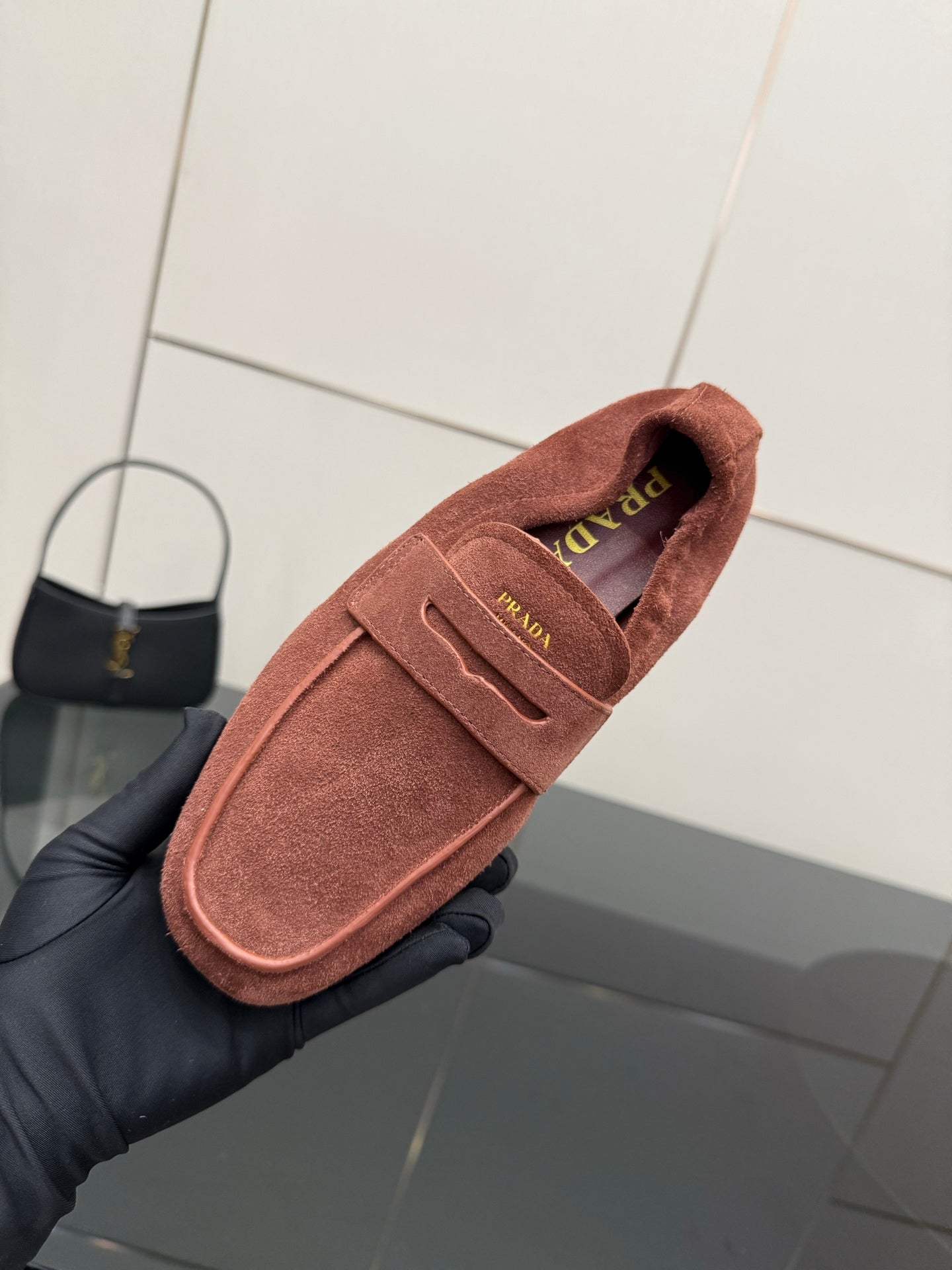 Prada rust-brown suede loafer close-up of insole logo and strap