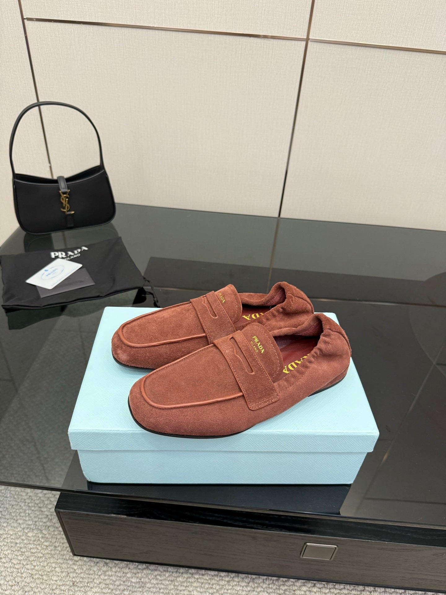 Prada rust-brown suede loafer with strap across vamp and soft lining