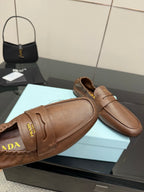 Tan leather loafer upper with stitched seam and Prada lettering on strap panel