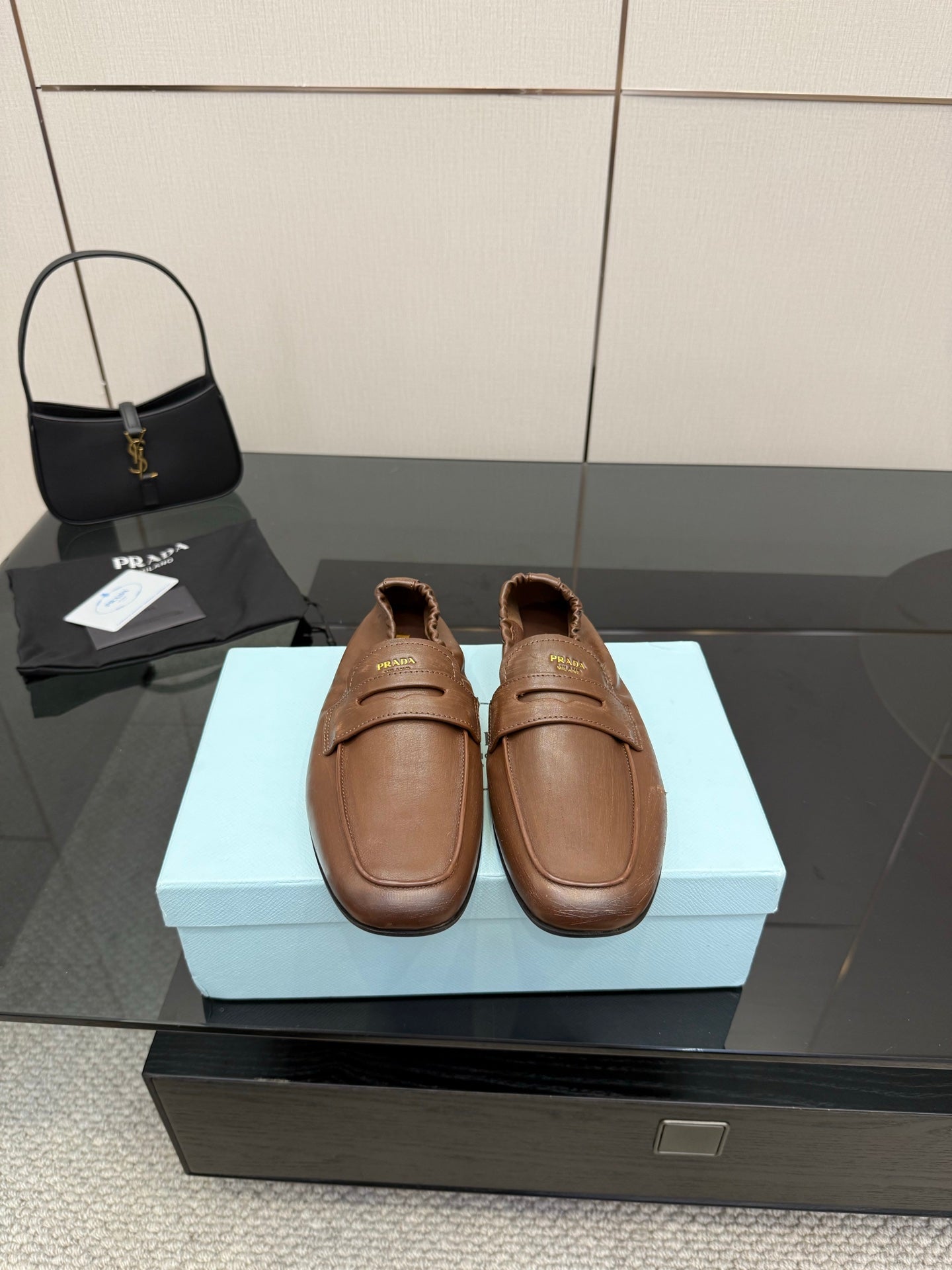 Prada ladies leather loafers, tan brown slip-on with top strap and stitched detail