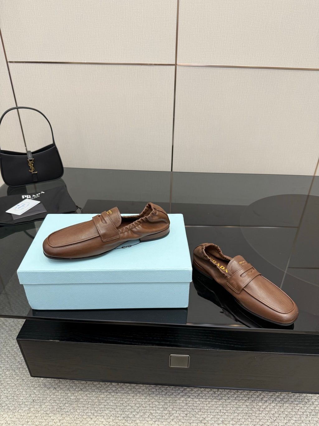 Tan leather loafers, slip-on style with strap detail and softly padded lining