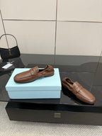 Tan leather loafers, slip-on style with strap detail and softly padded lining