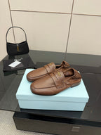 Brown leather loafers with strap over vamp and stitched upper detail, slip-on style