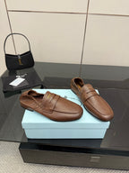 Tan leather loafers pair, rounded toe slip-on with stitched apron and strap detail