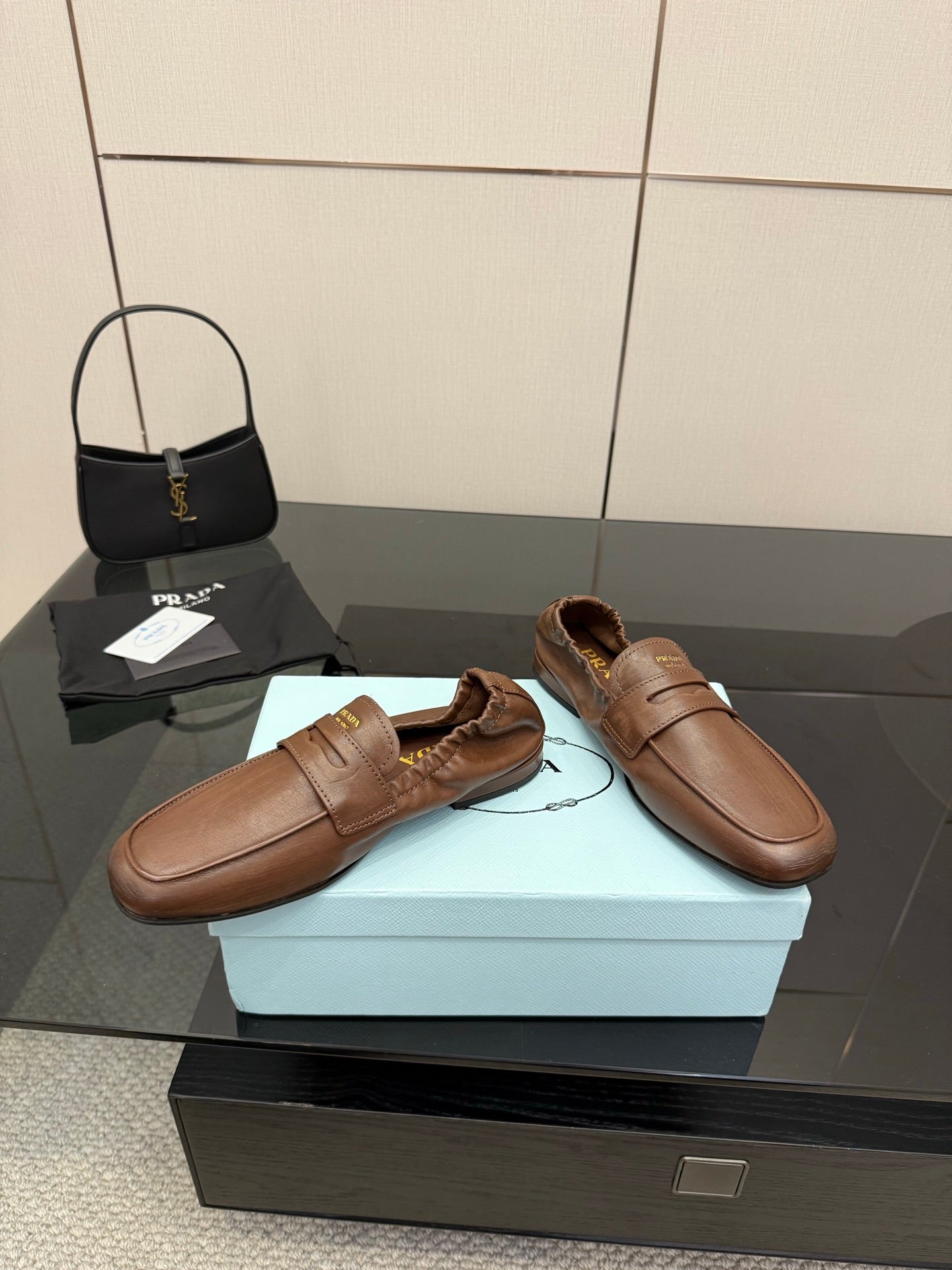 Tan leather slip-on loafers with one strap across vamp and visible seam stitching