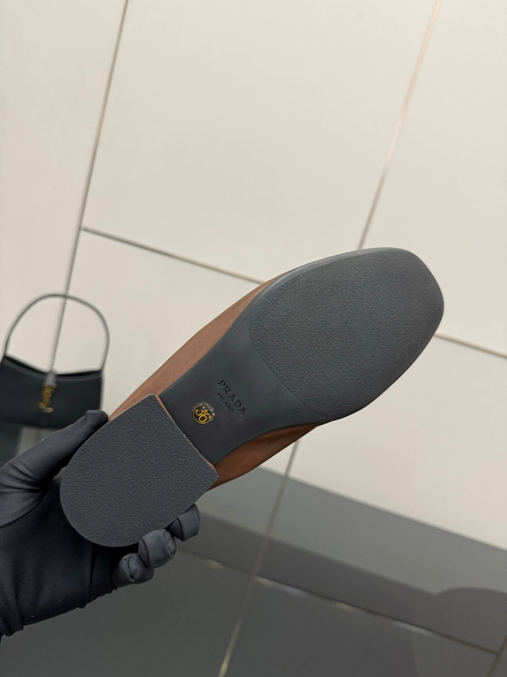 Loafer outsole with Prada logo, dark rubber sole underside close-up