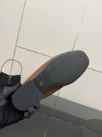 Loafer outsole with Prada logo, dark rubber sole underside close-up