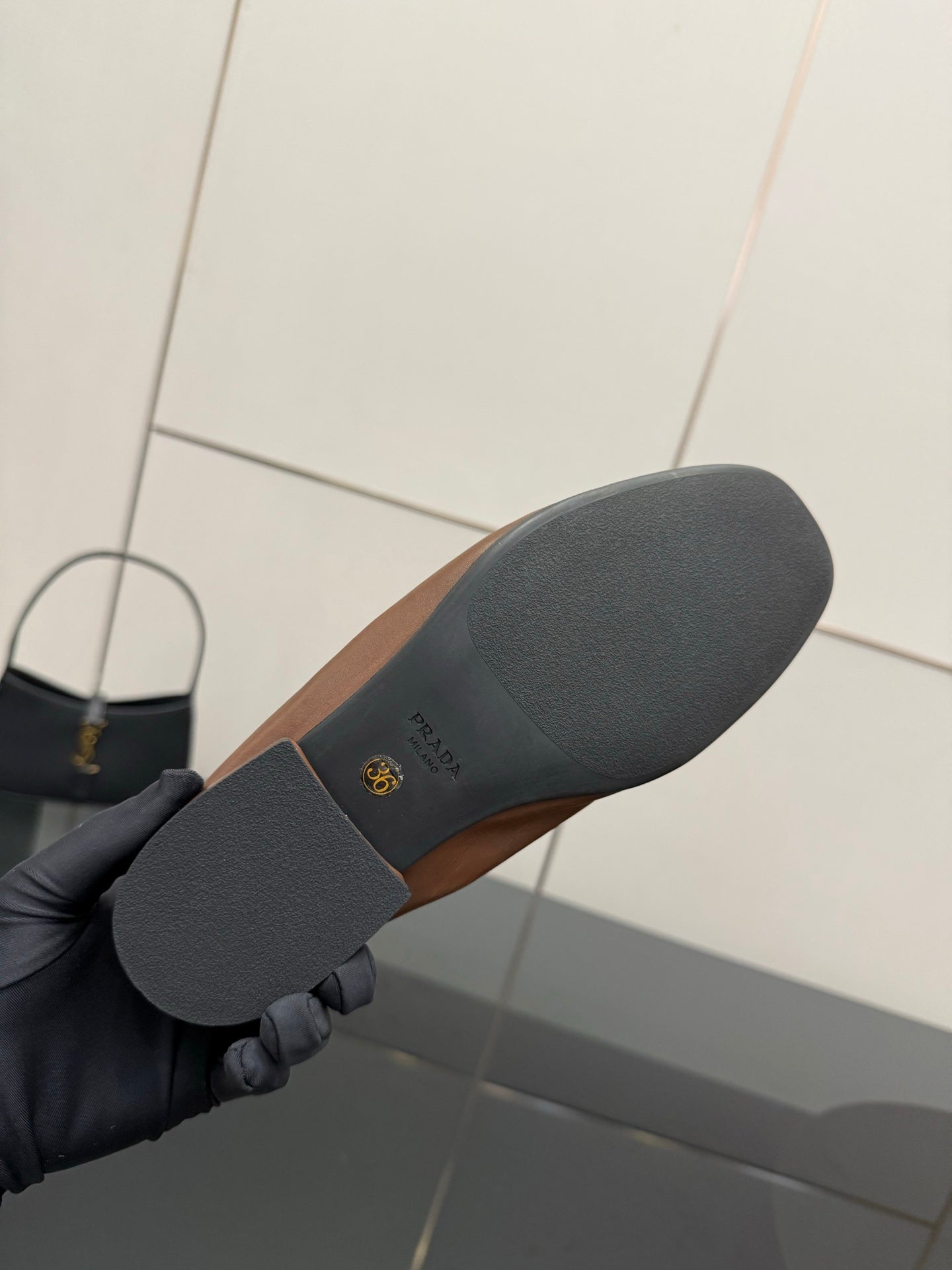 Loafer outsole with Prada logo, dark rubber sole underside close-up