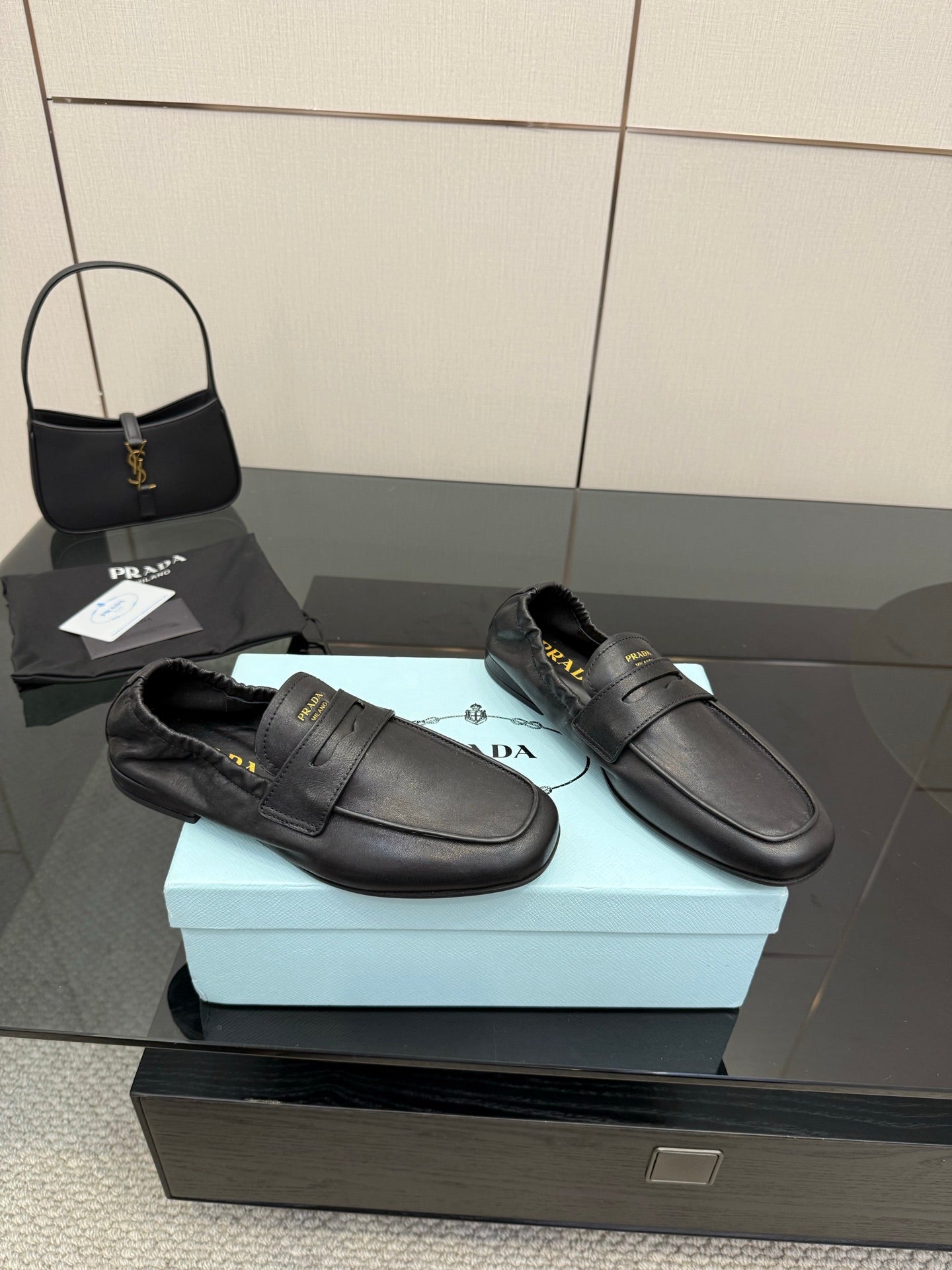 Black leather loafers with front strap and low block heel, fur-lined opening