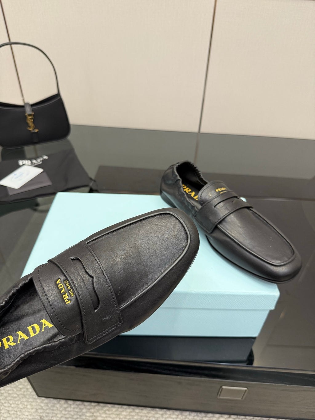 Black leather loafer close-up with front strap and stitched vamp seams