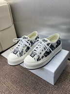 Unisex Dior sneakers, white with black palm-print sides, lace-up front and rubber sole
