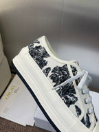 Unisex Dior sneakers close-up, white with black palm pattern, lace-up and thick sole