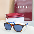 Tortoiseshell square sunglasses with blue-tinted lenses and blue detail on temples.