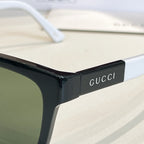 Black acetate sunglasses frame close-up with logo on the temple.