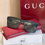 Black rectangular sunglasses with dark tinted lenses and glossy frame.