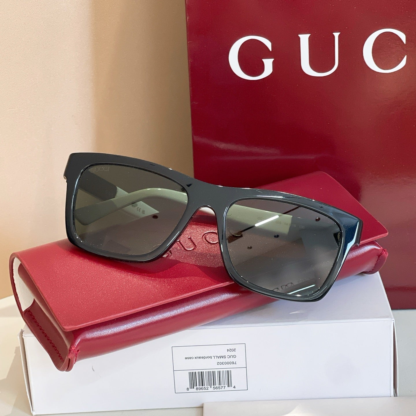 Black rectangular sunglasses with dark tinted lenses and glossy frame.