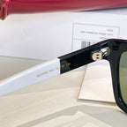 Black sunglasses temple with engraved numbers and gold-tone logo detail.