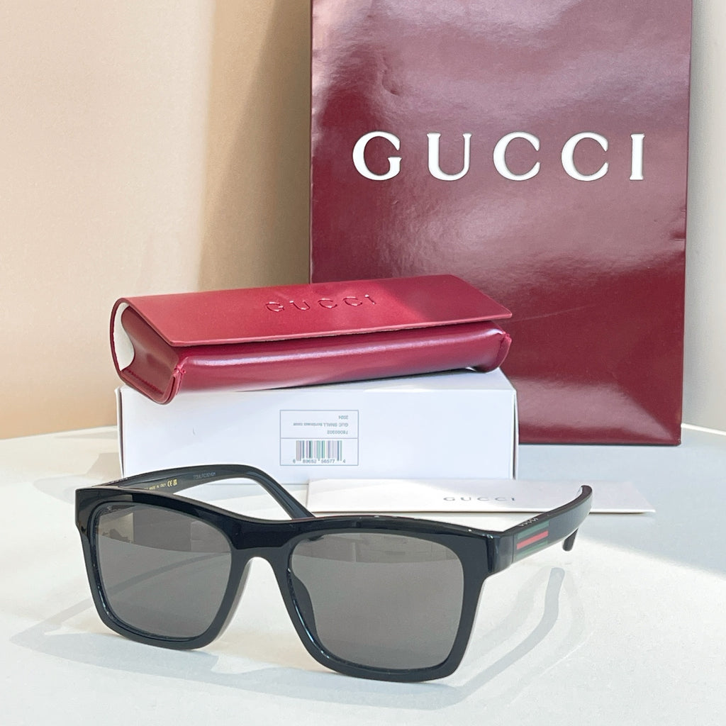 Black square sunglasses with smoke-gray lenses and thick acetate frame.