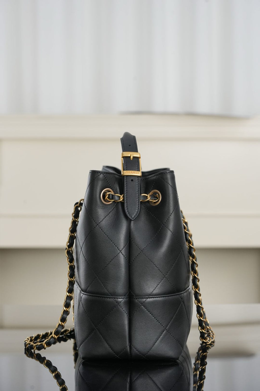 Chanel quilted drawstring-style shoulder bag with gold chain straps and leather cord