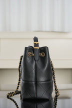 Chanel quilted black bucket bag with gold hardware and chain shoulder straps