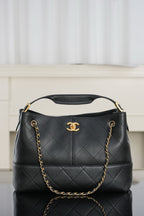 Chanel quilted shoulder bag, dark leather with gold chain handle and CC logo