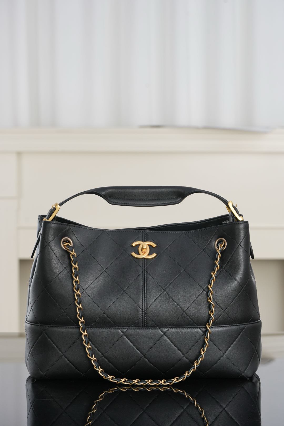 Chanel quilted shoulder bag, dark leather with gold chain handle and CC logo