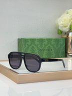 Black square sunglasses with dark lenses and Gucci logo on temple