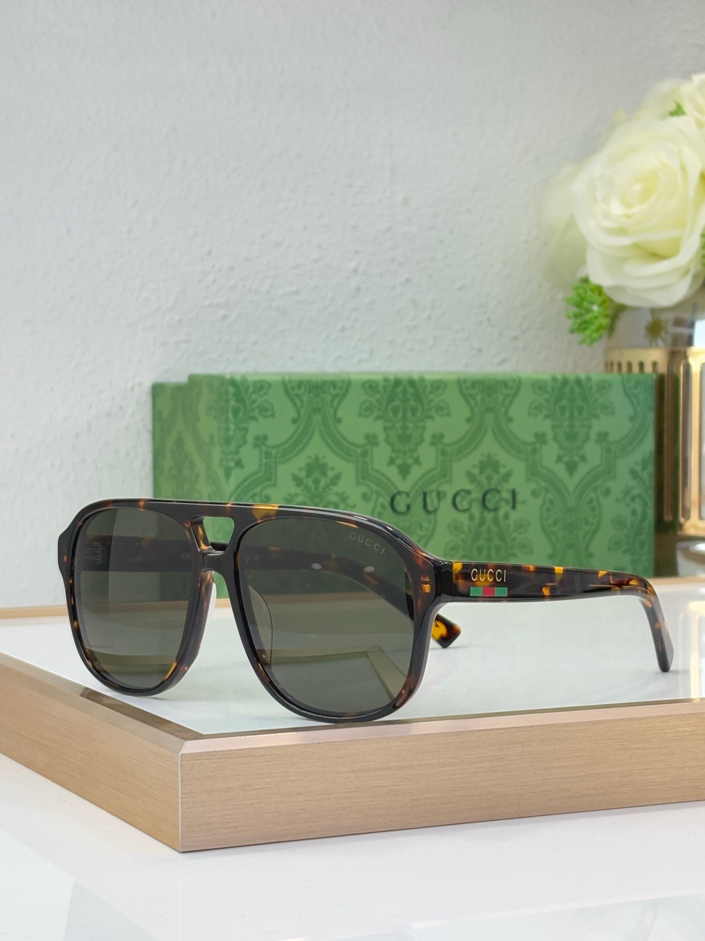 Tortoiseshell sunglasses with warm amber lenses and Gucci logo on temple