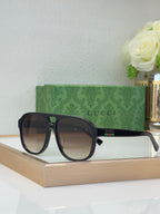 Dark tortoiseshell sunglasses with brown lenses and Gucci logo on temple
