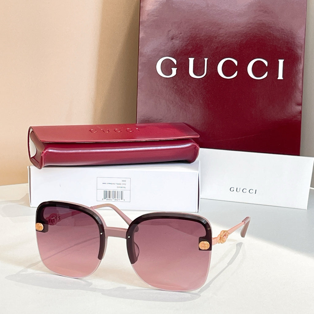 Gucci sunglasses with dark frame, pink-to-lavender gradient lenses, gold details