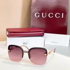 Gucci sunglasses with dark frame, pink-to-lavender gradient lenses, gold details